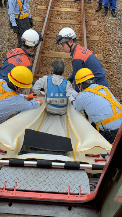 シューターを使って車両から線路へ滑り降りていく様子。